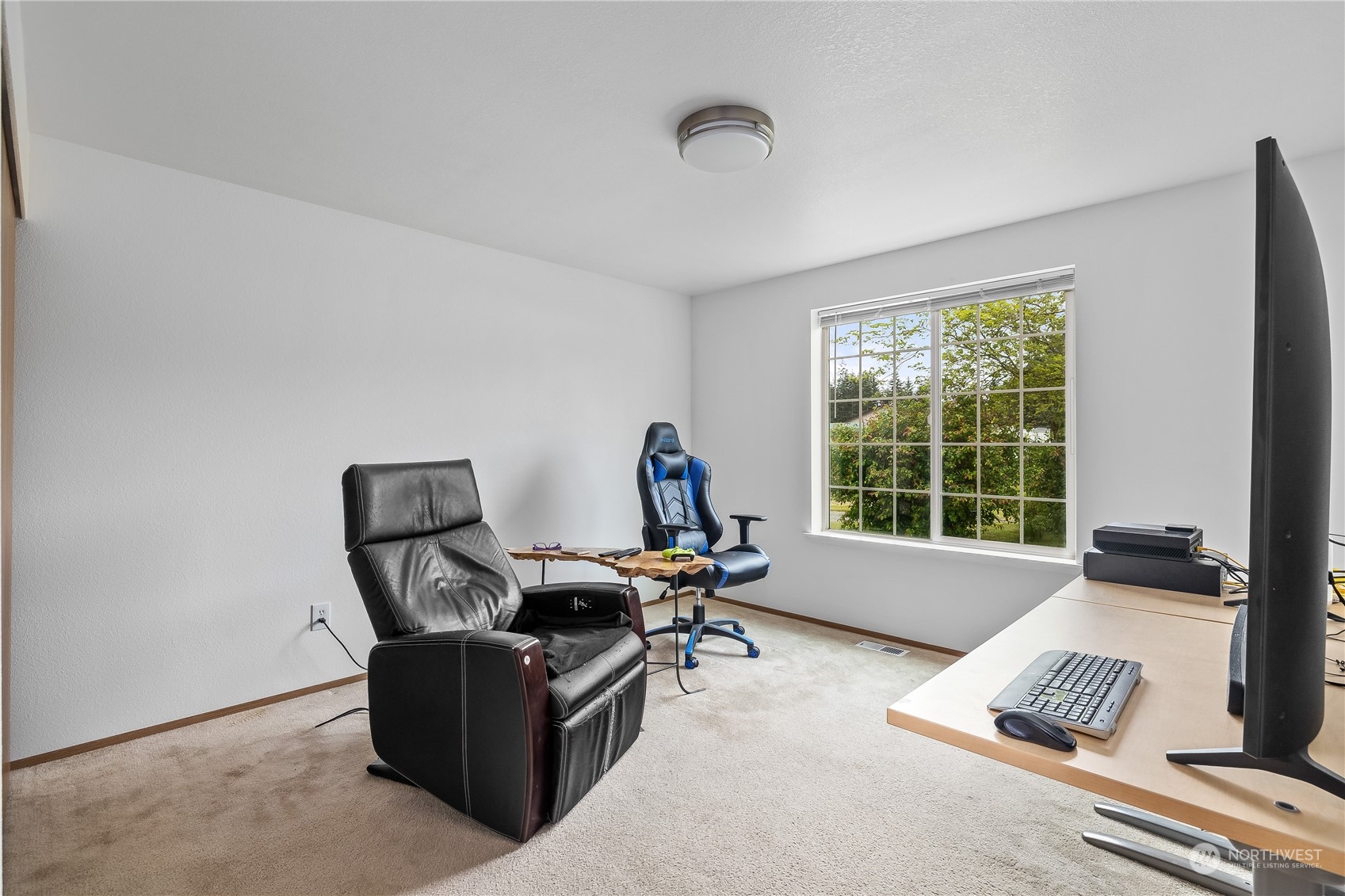 10532 School Land Road Southwest Rochester, WA 98579 - Photo 21 of 23 a living room with furniture and a window