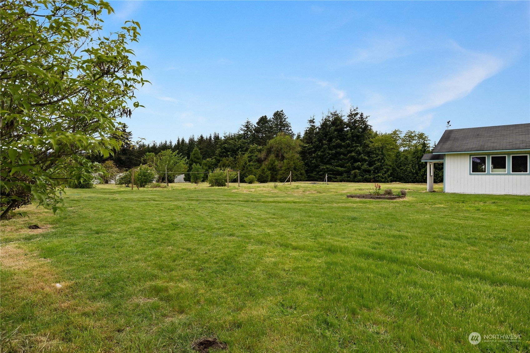 10532 School Land Road Southwest Rochester, WA 98579 - Photo 5 of 23 a view of a white house with a big yard