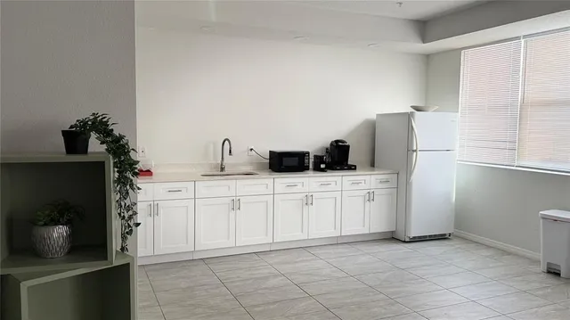 a kitchen with cabinets and white appliances