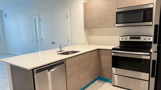 a kitchen with a sink cabinets and microwave