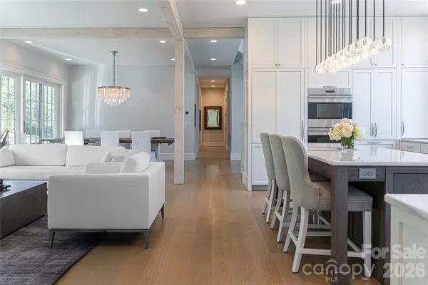 a living room with furniture and kitchen view