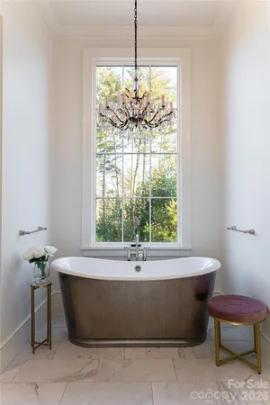 a bath tub sitting in a bathroom next to a window