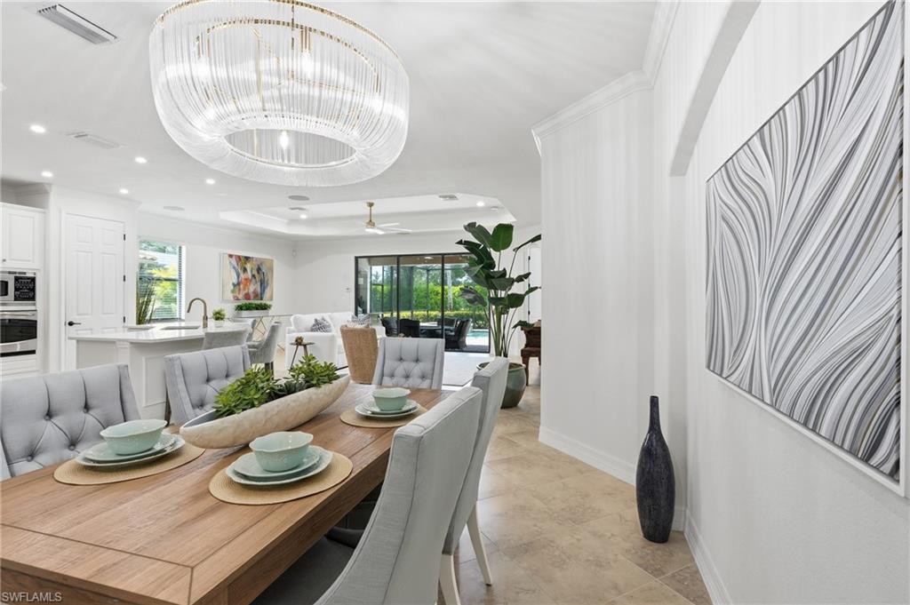 9479 Piacere Way Naples, FL 34113 - Photo 12 of 48 Recessed lighting, crown molding, wood-finish dining table, coffered ceiling, and large format tile flooring