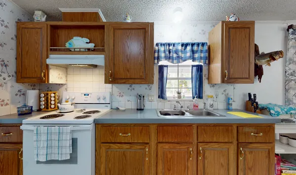 a kitchen with stainless steel appliances a sink stove and refrigerator