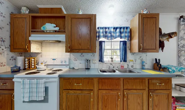 a kitchen with stainless steel appliances a sink stove and refrigerator