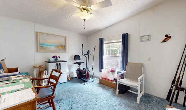 a view of a livingroom with furniture and a window