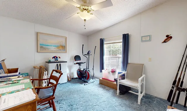 a view of a livingroom with furniture and a window