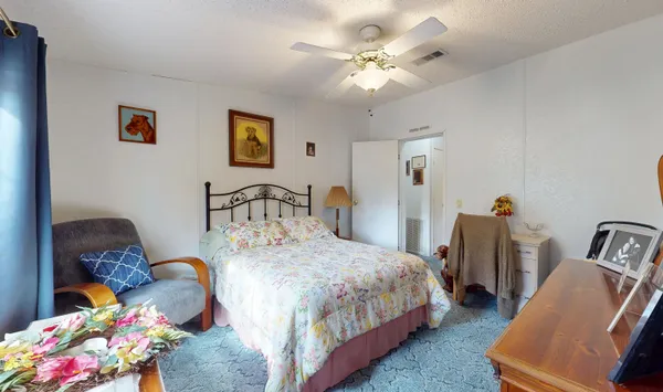 a bedroom with bed and a chandelier