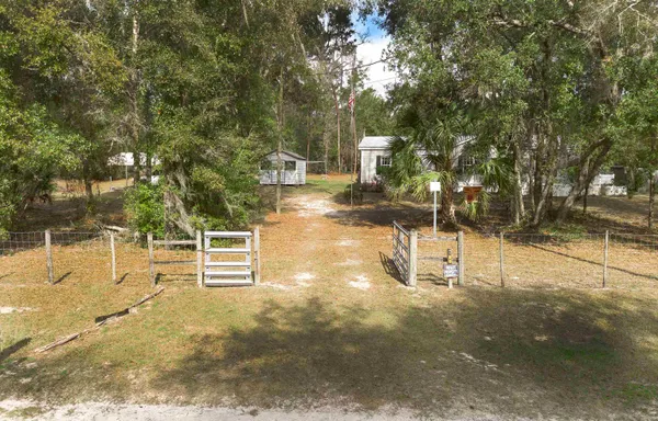 a view of a yard with wooden fence