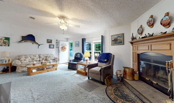 a living room with furniture fireplace and a window