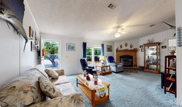a living room with furniture fireplace and a window