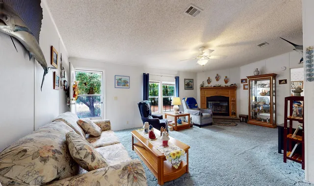 a living room with furniture fireplace and a window