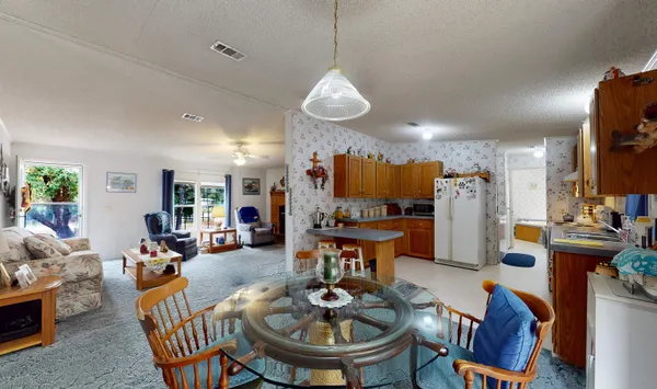 a living room with furniture a fireplace and a chandelier