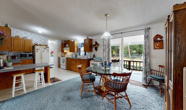 a dining room with furniture a chandelier and window