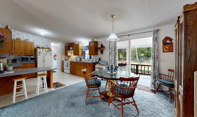 a dining room with furniture a chandelier and window