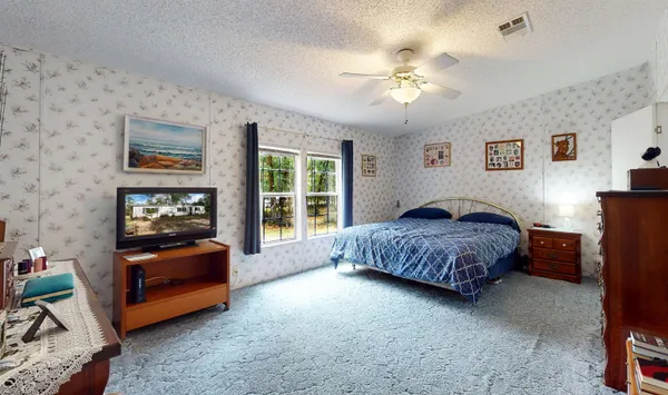 a bedroom with a bed and a chandelier