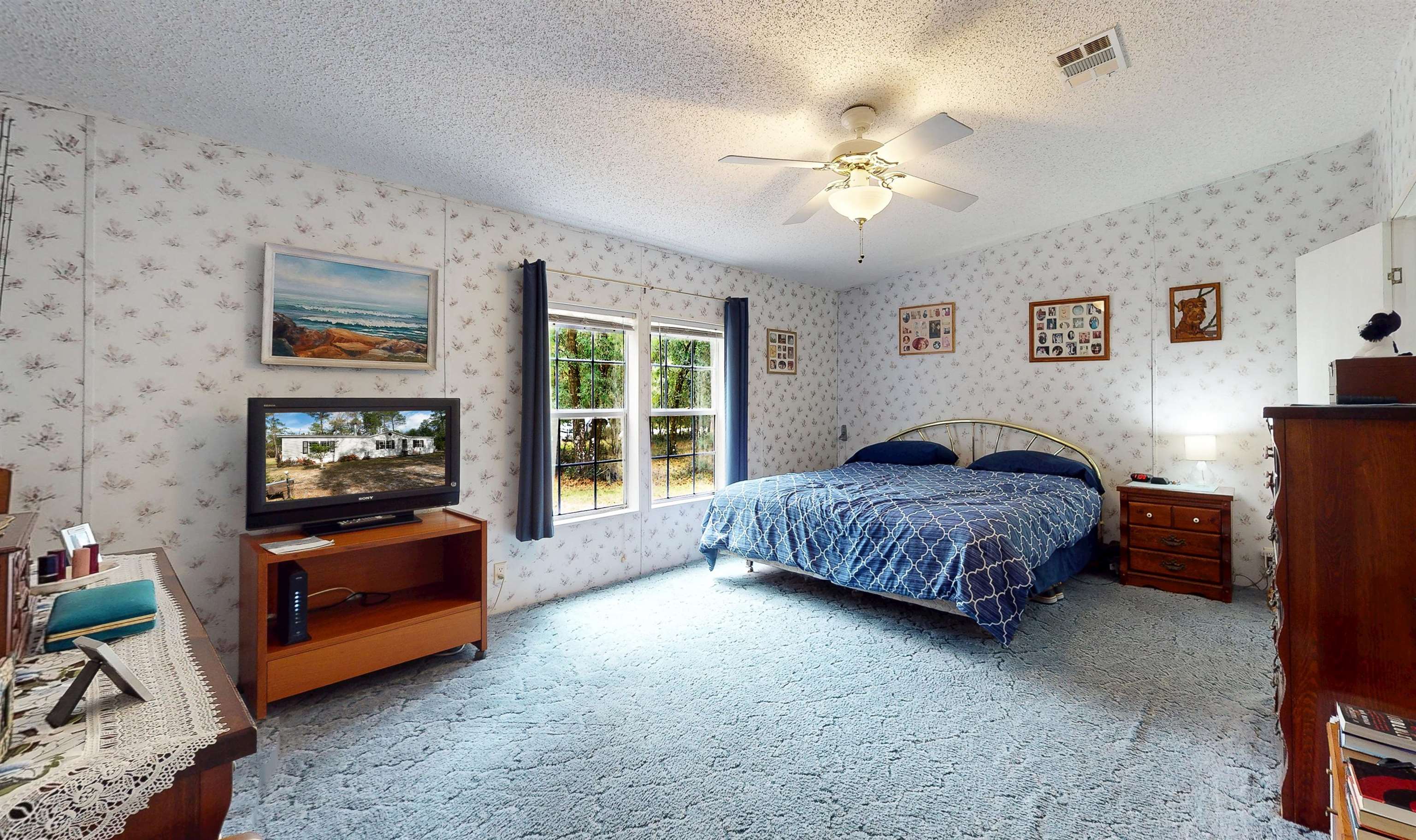 100 Harper Place Satsuma, FL 32189 - Photo 8 of 32 a bedroom with a bed and a chandelier