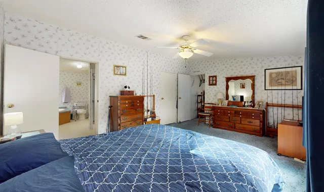 a bedroom with furniture and a chandelier