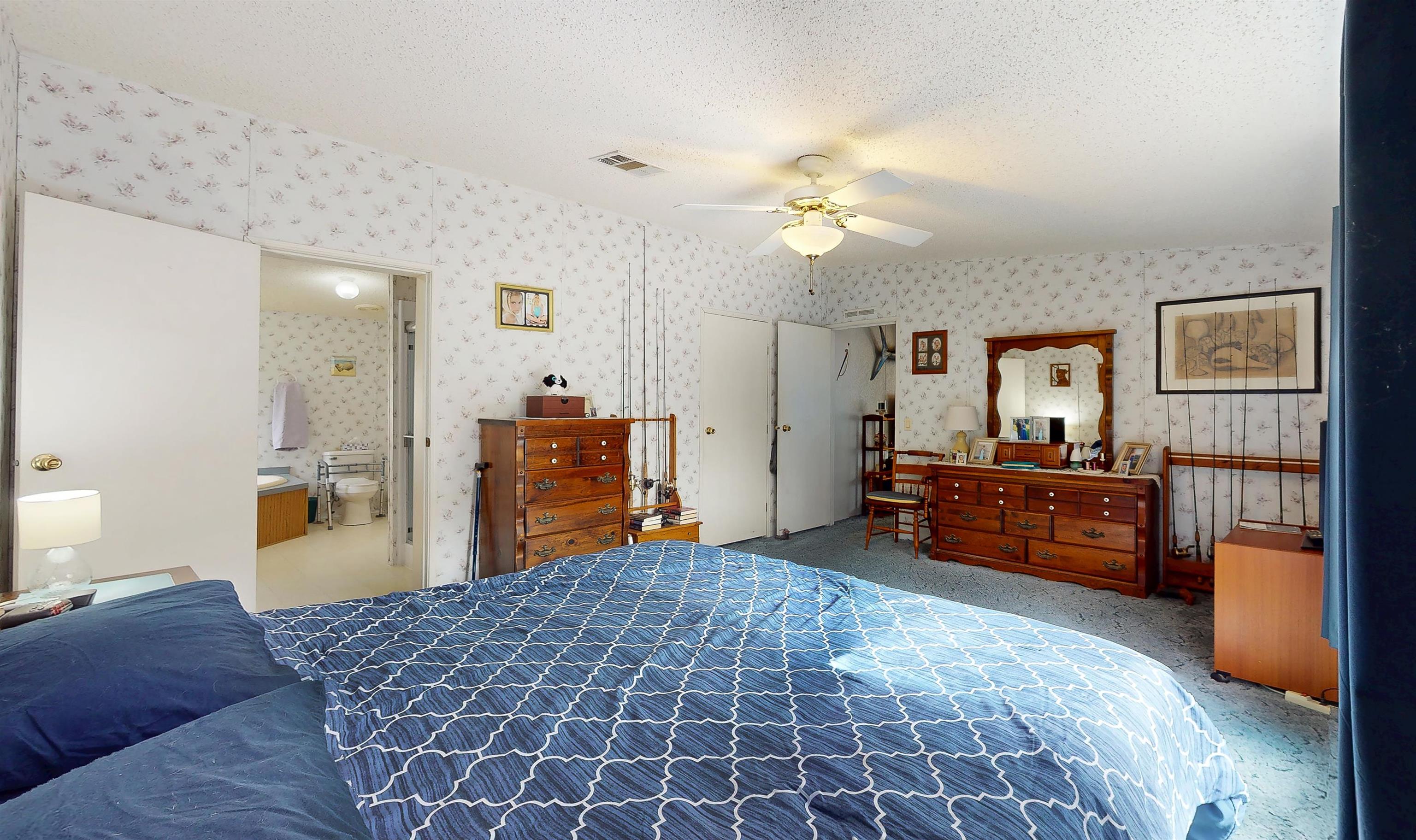 100 Harper Place Satsuma, FL 32189 - Photo 9 of 32 a bedroom with furniture and a chandelier