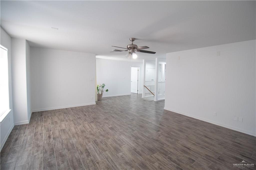 1307 Rio Grande Street San Juan, TX 78589 - Photo 11 of 23 wooden floor in an empty room with a window