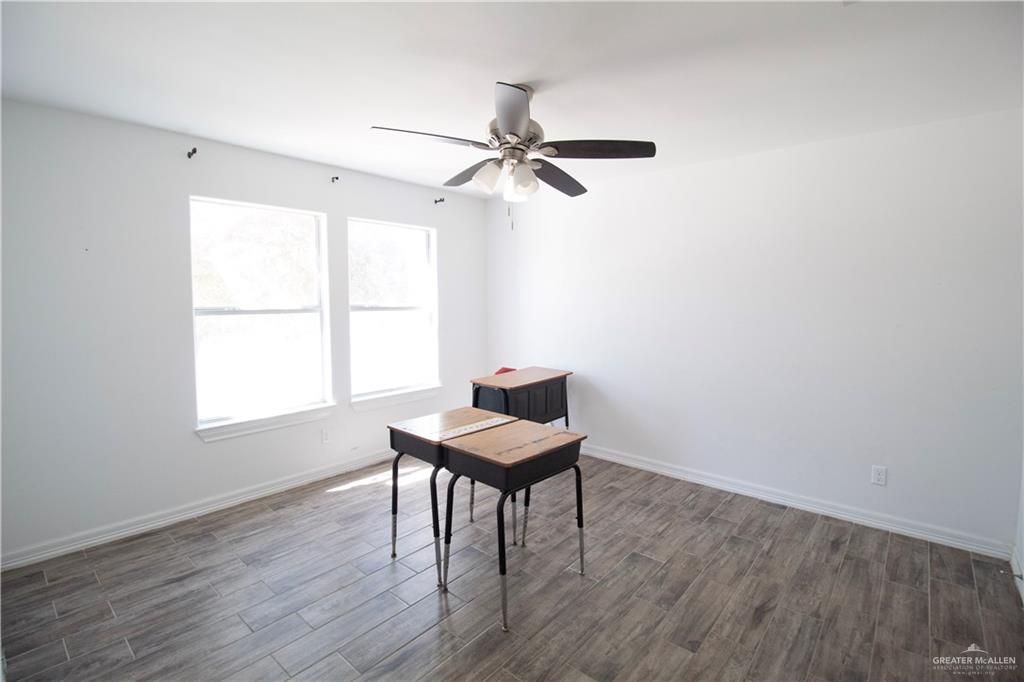 1307 Rio Grande Street San Juan, TX 78589 - Photo 13 of 23 a view of a workspace with furniture and a window