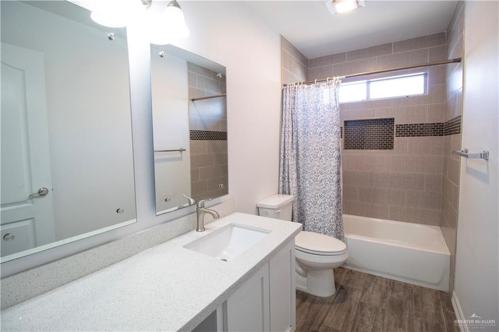 1307 Rio Grande Street San Juan, TX 78589 - Photo 15 of 23 a bathroom with a sink a toilet and shower