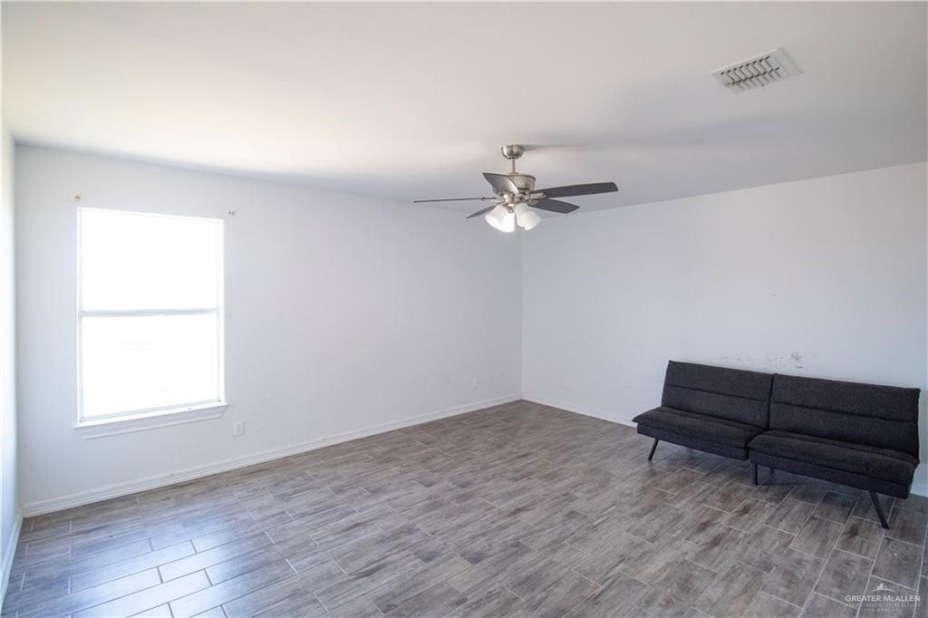 1307 Rio Grande Street San Juan, TX 78589 - Photo 16 of 23 wooden floor in an empty room with a window
