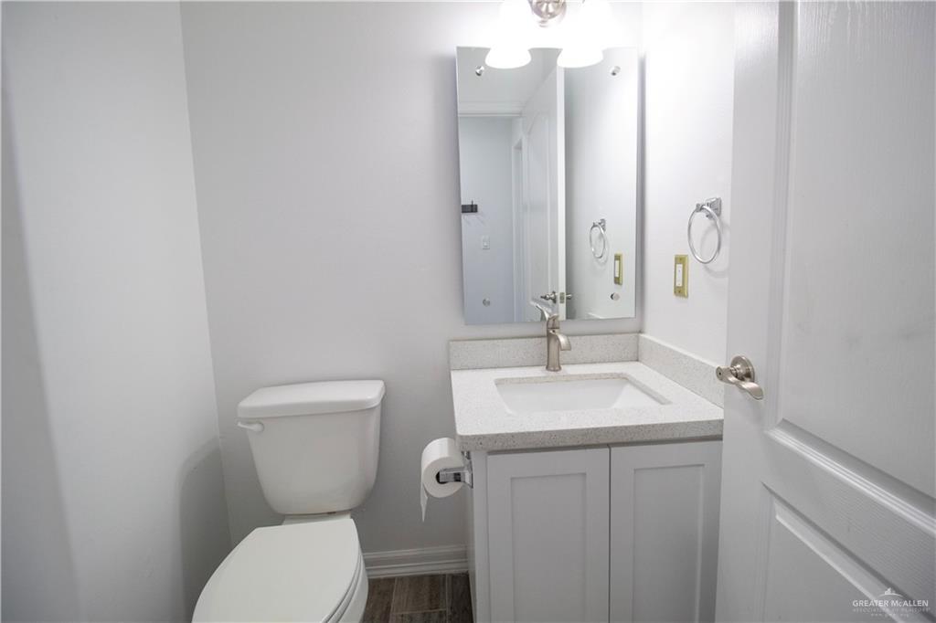 1307 Rio Grande Street San Juan, TX 78589 - Photo 19 of 23 a bathroom with a toilet sink and mirror