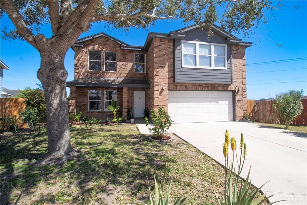 1307 Rio Grande Street San Juan, TX 78589 - Photo 2 of 23 a front view of a house with garden