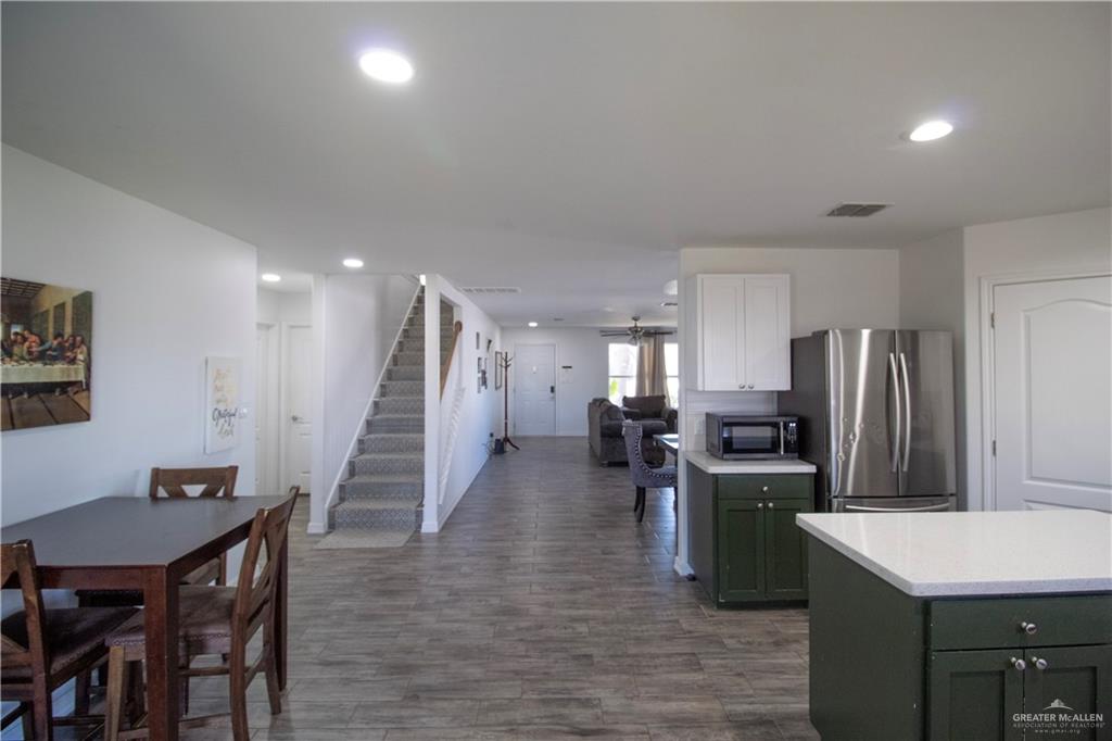 1307 Rio Grande Street San Juan, TX 78589 - Photo 7 of 23 a kitchen with refrigerator and chairs