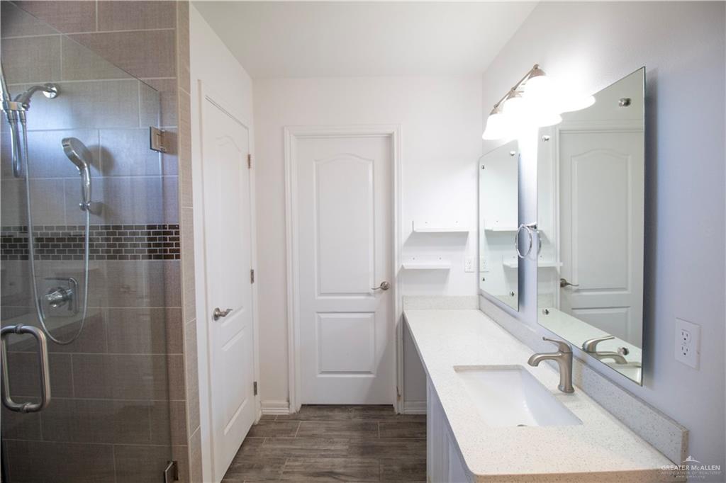 1307 Rio Grande Street San Juan, TX 78589 - Photo 9 of 23 a bathroom with a sink a double vanity and shower