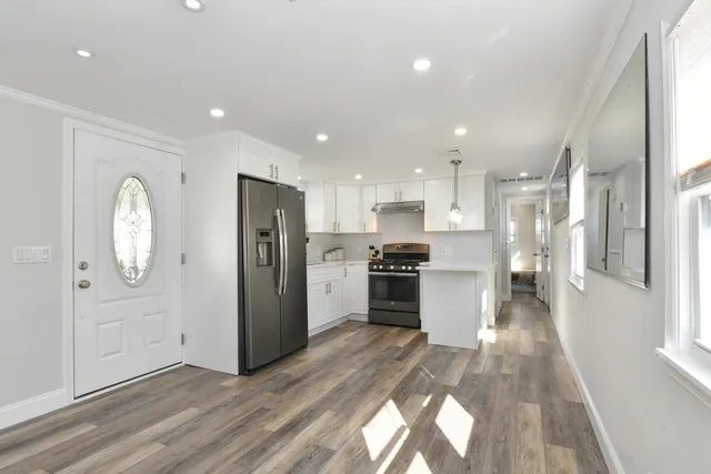 a kitchen with a refrigerator and a sink