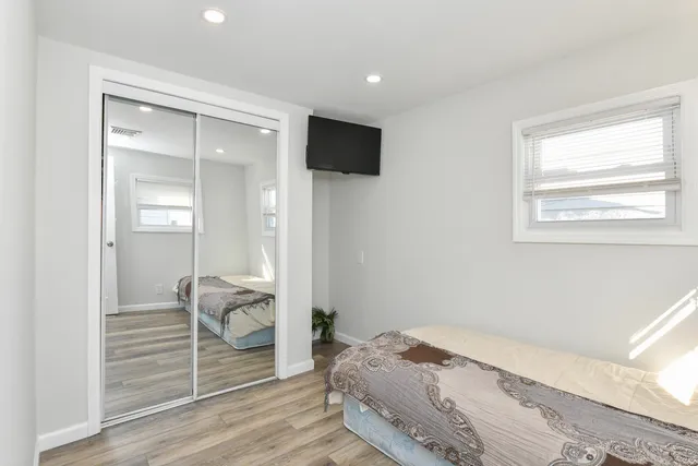 a bedroom with a bed and a flat screen tv