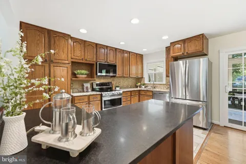 a kitchen with stainless steel appliances a stove sink and microwave