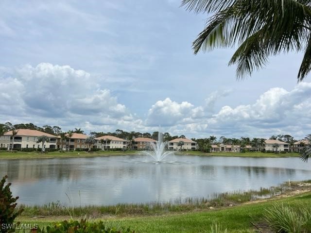 18238 Creekside Preserve Loop, Unit 102 Fort Myers, FL 33908 - Photo 1 of 24 a view of a lake with houses in the back