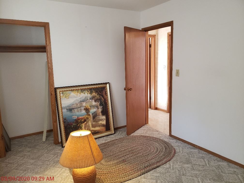 2432 Freeport Road Rockton, IL 61072 - Photo 16 of 22 a view of a bedroom with wooden floor and couch