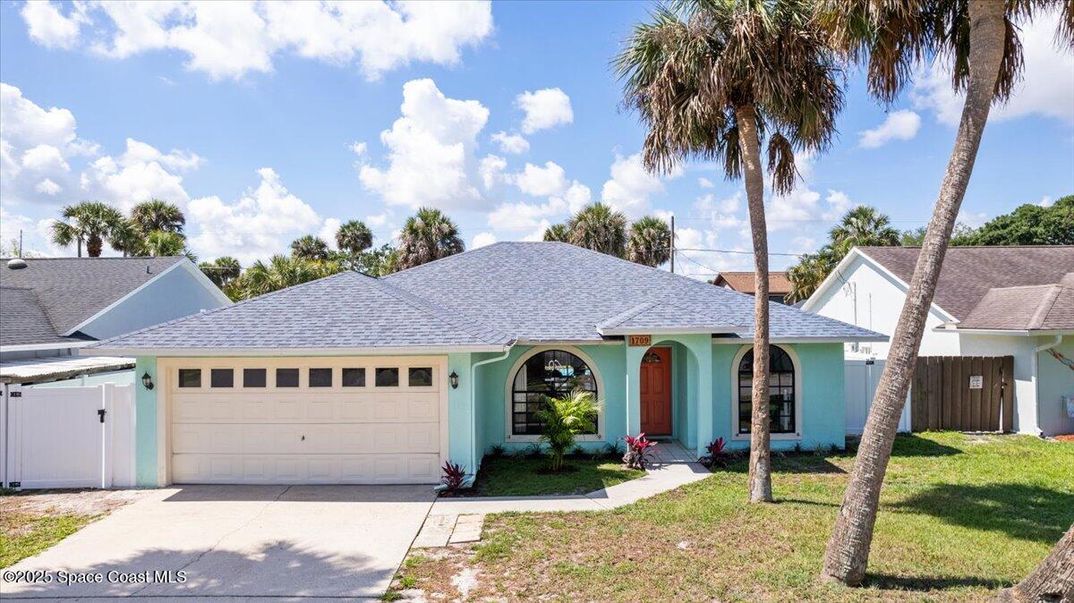 1709 Palm Ridge Road Melbourne, FL 32935 - Photo 1 of 43 a view of a house with a yard and potted plants