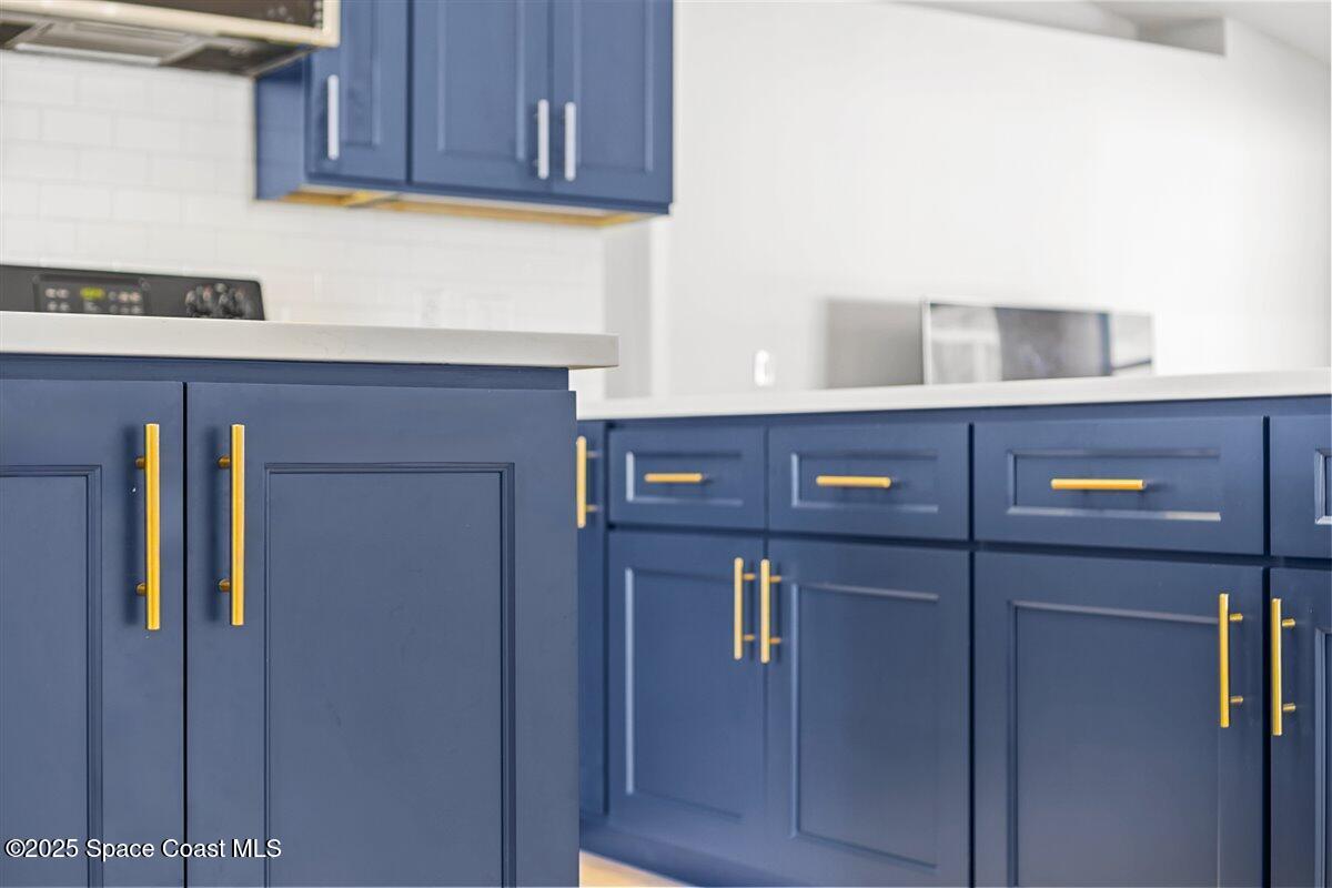 1709 Palm Ridge Road Melbourne, FL 32935 - Photo 14 of 43 a kitchen with stainless steel appliances cabinets and refrigerator