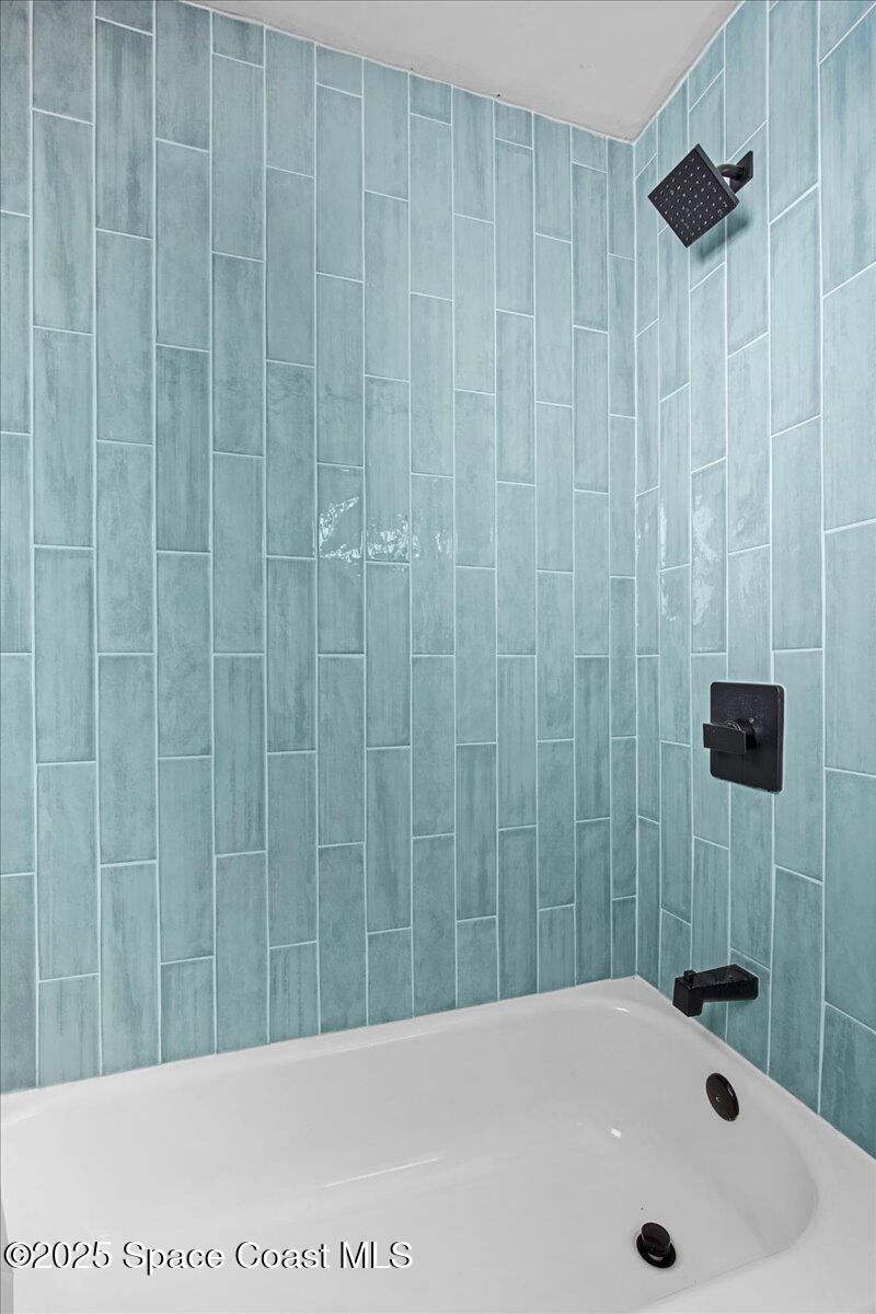 1709 Palm Ridge Road Melbourne, FL 32935 - Photo 23 of 43 a bathroom with a shower