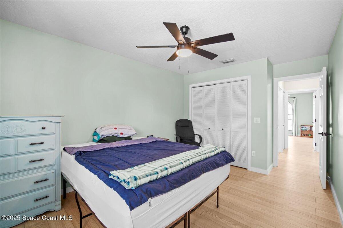 1709 Palm Ridge Road Melbourne, FL 32935 - Photo 29 of 43 a bed room with a bed and a chandelier