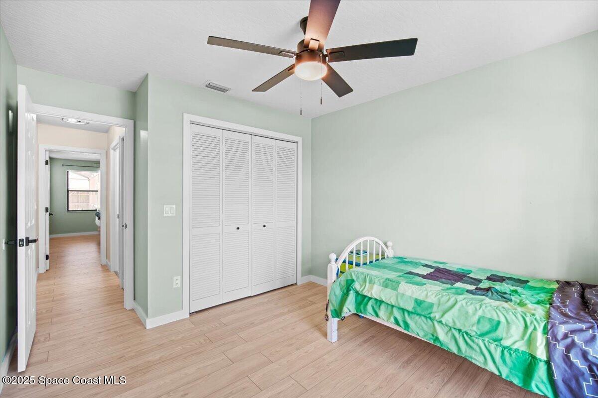 1709 Palm Ridge Road Melbourne, FL 32935 - Photo 33 of 43 a room with a bed and a chandelier