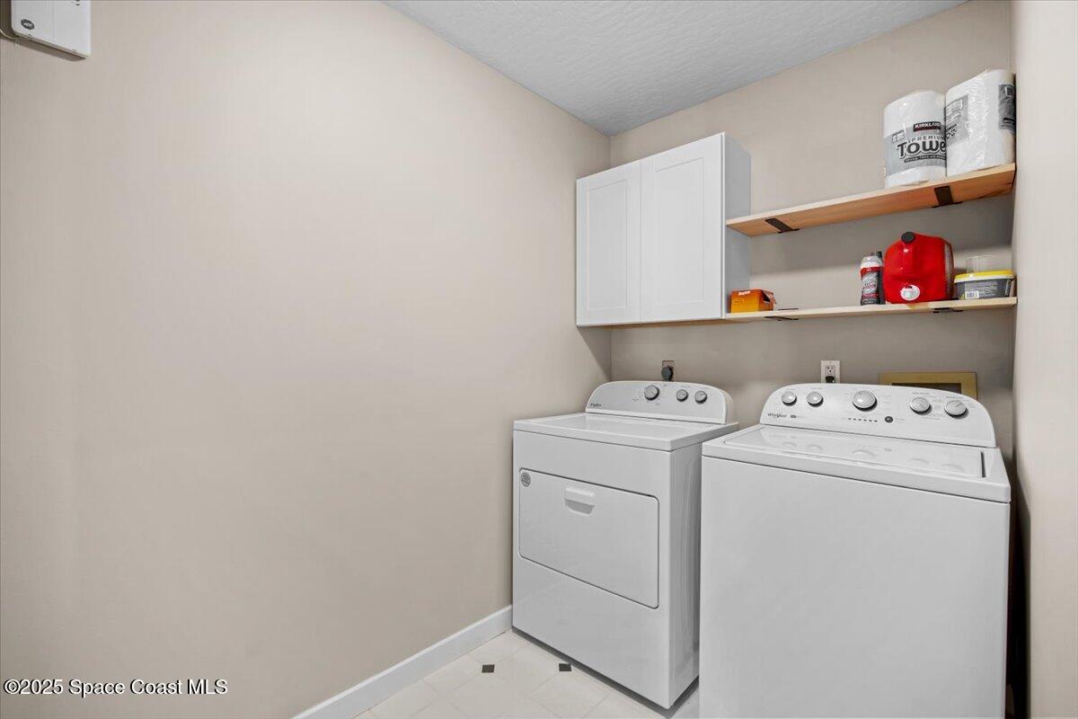 1709 Palm Ridge Road Melbourne, FL 32935 - Photo 34 of 43 a utility room with dryer and washer
