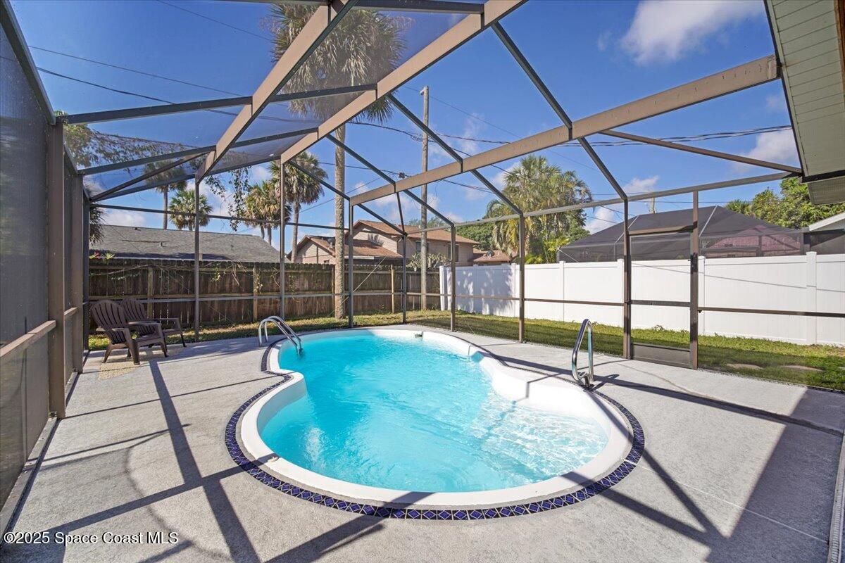 1709 Palm Ridge Road Melbourne, FL 32935 - Photo 38 of 43 a view of a swimming pool with a patio