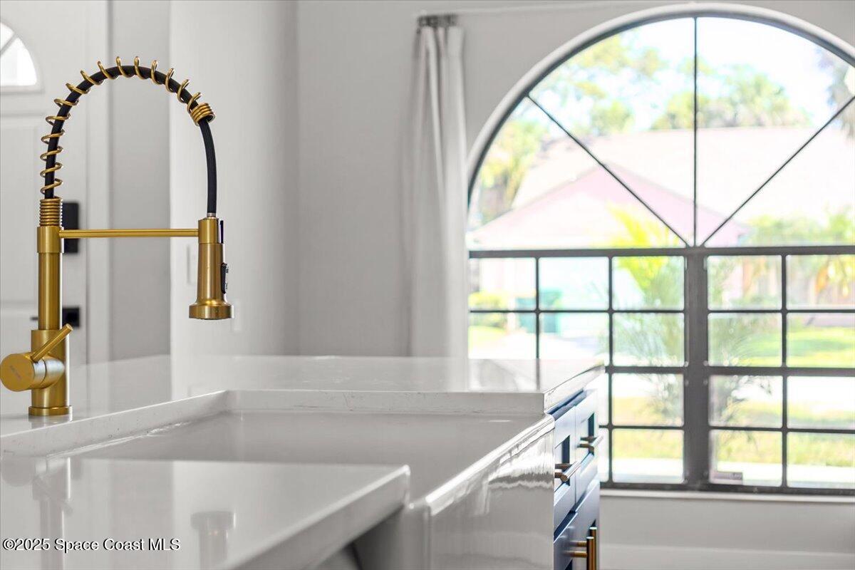 1709 Palm Ridge Road Melbourne, FL 32935 - Photo 10 of 43 a view of a floor to ceiling window with kitchen view