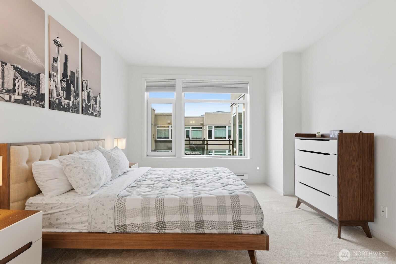 2000 Alaskan Way, Unit 553 Seattle, WA 98121 - Photo 17 of 33 a bedroom with a bed and a dresser
