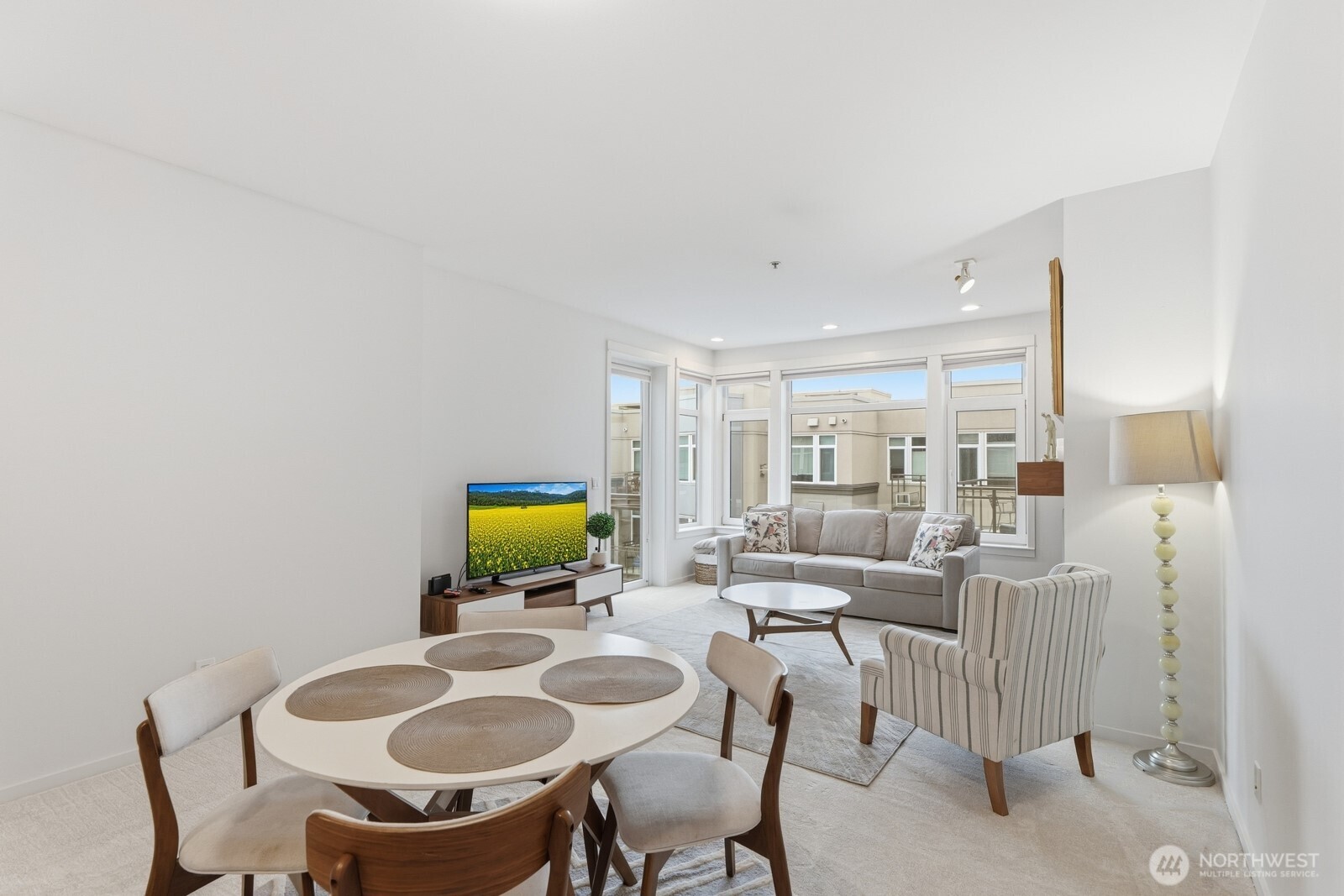 2000 Alaskan Way, Unit 553 Seattle, WA 98121 - Photo 9 of 33 a living room with furniture a flat screen tv and a rug