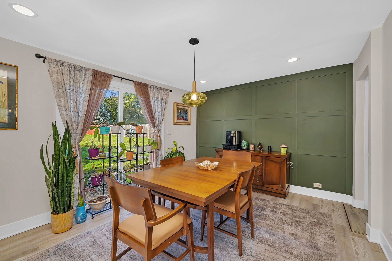 128 South Villa Avenue Addison, IL 60101 - Photo 13 of 43 a dining room with furniture potted plants and wooden floor