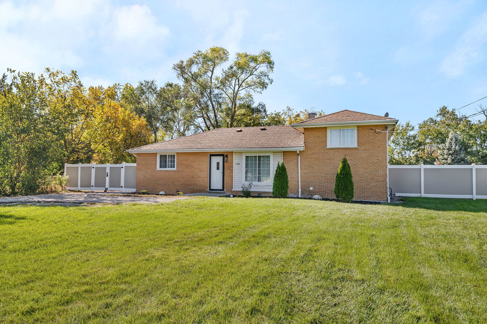 128 South Villa Avenue Addison, IL 60101 - Photo 2 of 43 a front view of a house with a yard and garage
