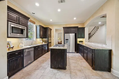 a bathroom with a tub a sink a mirror and a shower