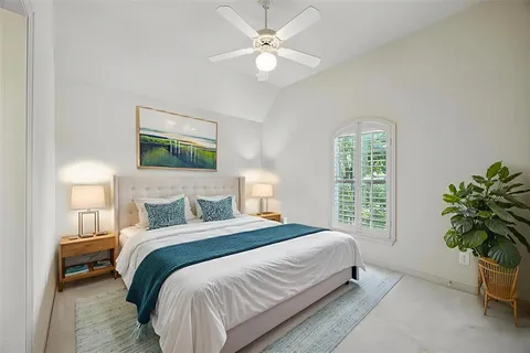 an aerial view of residential houses with outdoor space and trees